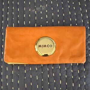 Mimco has Clutch with Golden Emblem
